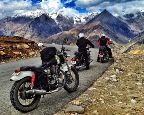 Rider crossing Khardung La Pass during Leh Ladakh bike tour